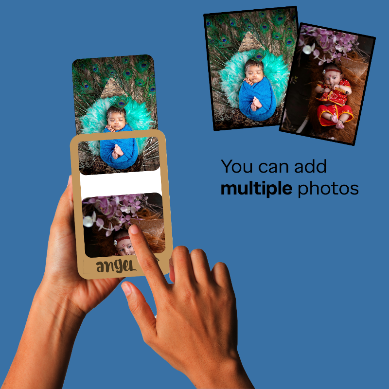 Hands holding a photo album with multiple photos of a baby on a blue background.
