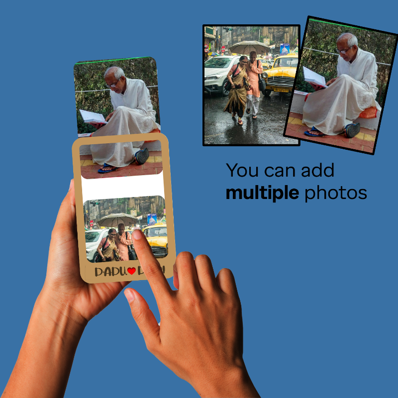 Hand holding a photo album with images of people and cars on a blue background.