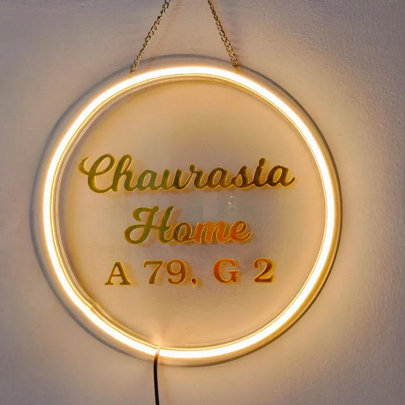 Neon sign with 'home name' and address on a white background
