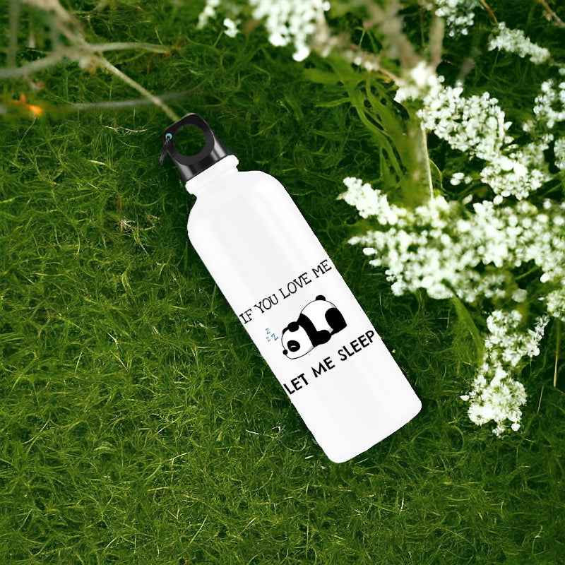 White water bottle with panda design and text on grass