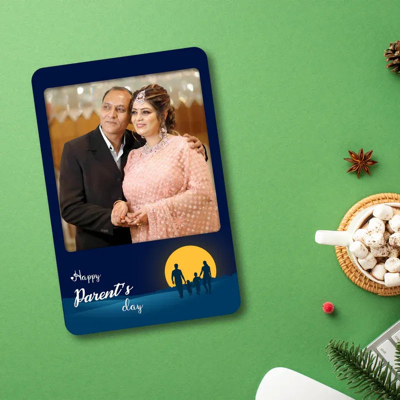 Fridge Magnet with a photo of a couple on a green background with festive elements.