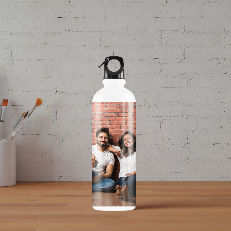 A white water bottle with a custom print of a couple, making it appear as if the photo was taken from the bottle.