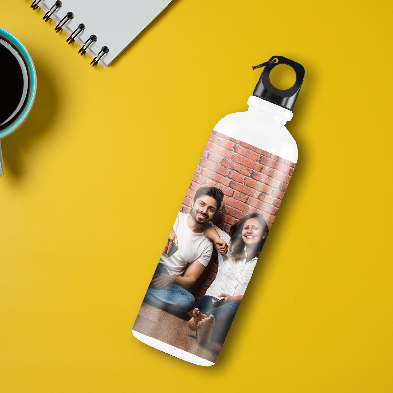 Personalized water bottle with a photo of two people on a yellow background