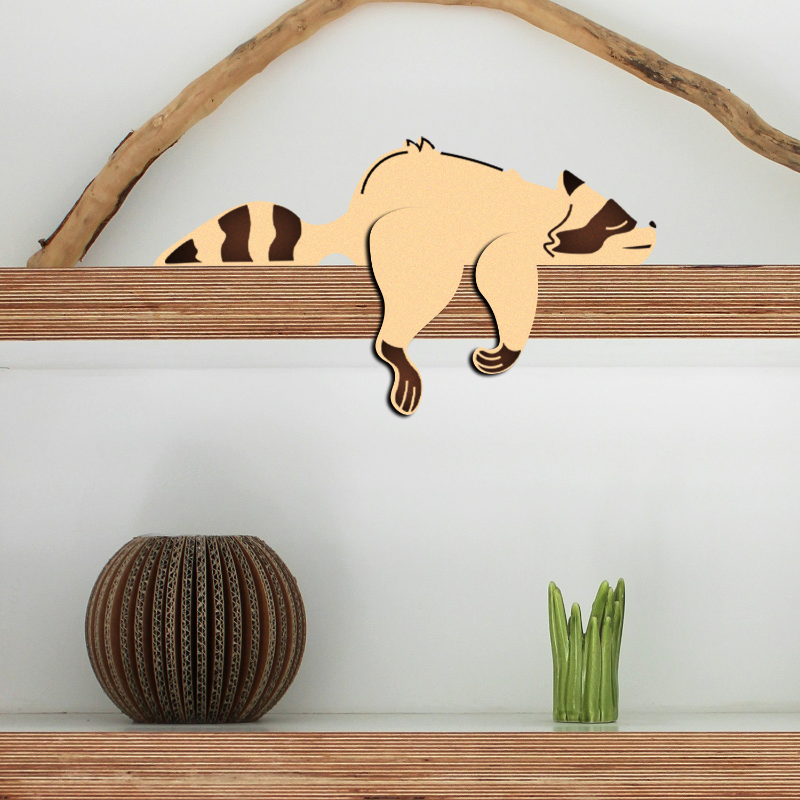 Wooden raccoon wall decoration on a wooden shelf with a white background