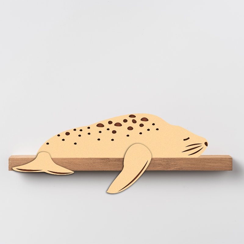 Wooden seal-shaped cutting board on a light gray background