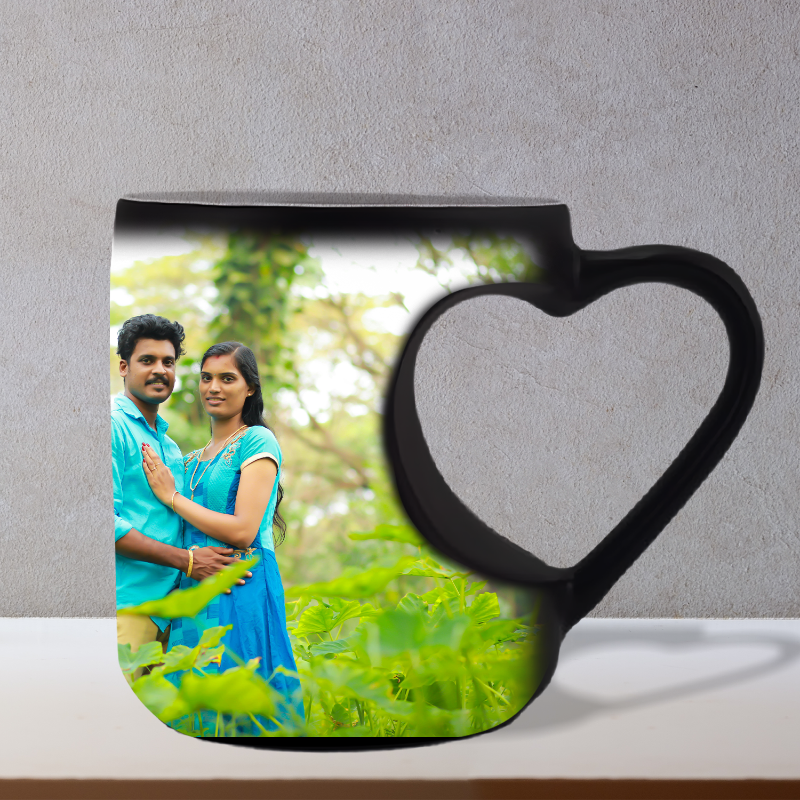 Mug with heart handle featuring a printed image of a couple in a garden