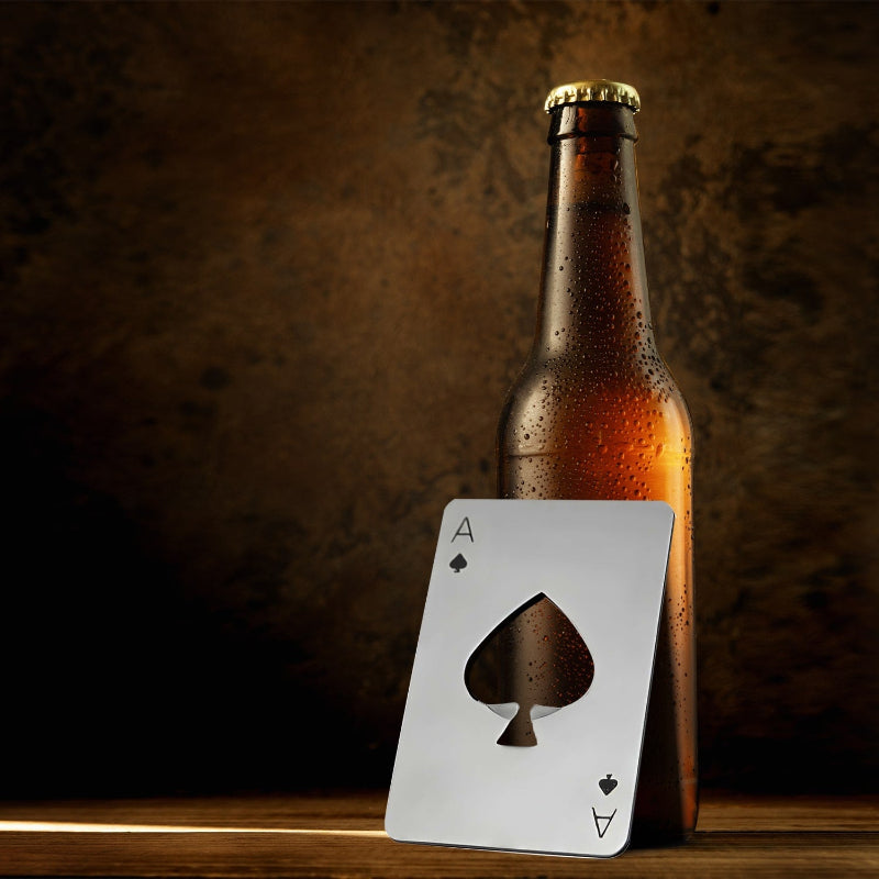 Beer bottle opener, ace of spades on a wooden surface.