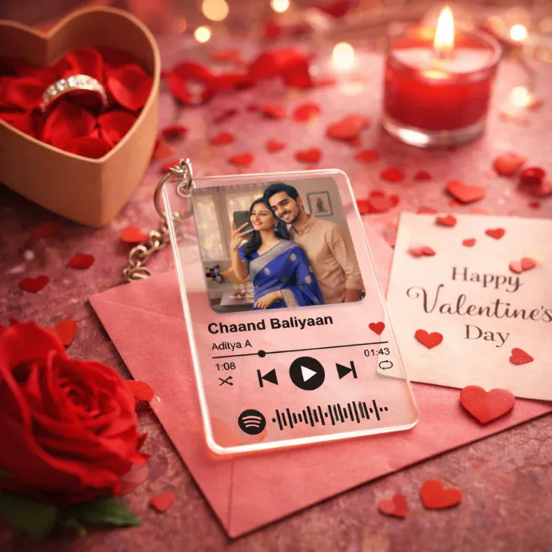 Spotify keychain with a couple's photo, red rose, heart-shaped box, and 'Happy Valentine's Day' card on a romantic setting.