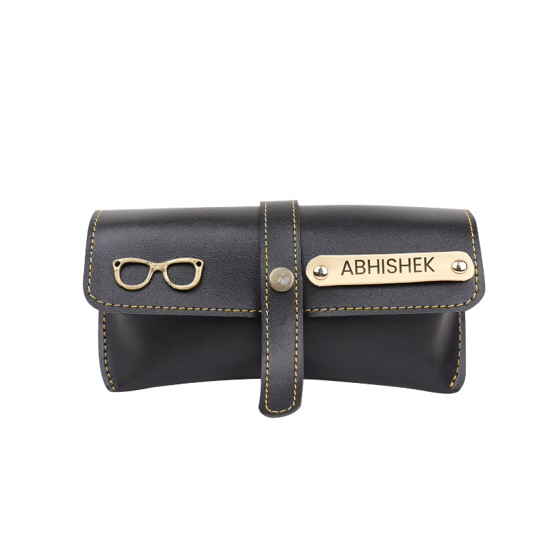 Black leather case with gold accents featuring a nameplate and small icon on a white background