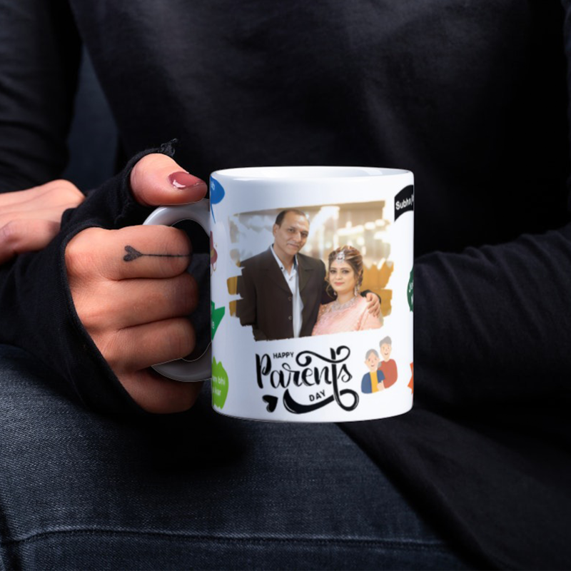 A ceramic mug with a photo insert of a couple, holding the mug with a photo of their son and daughter-in-law.