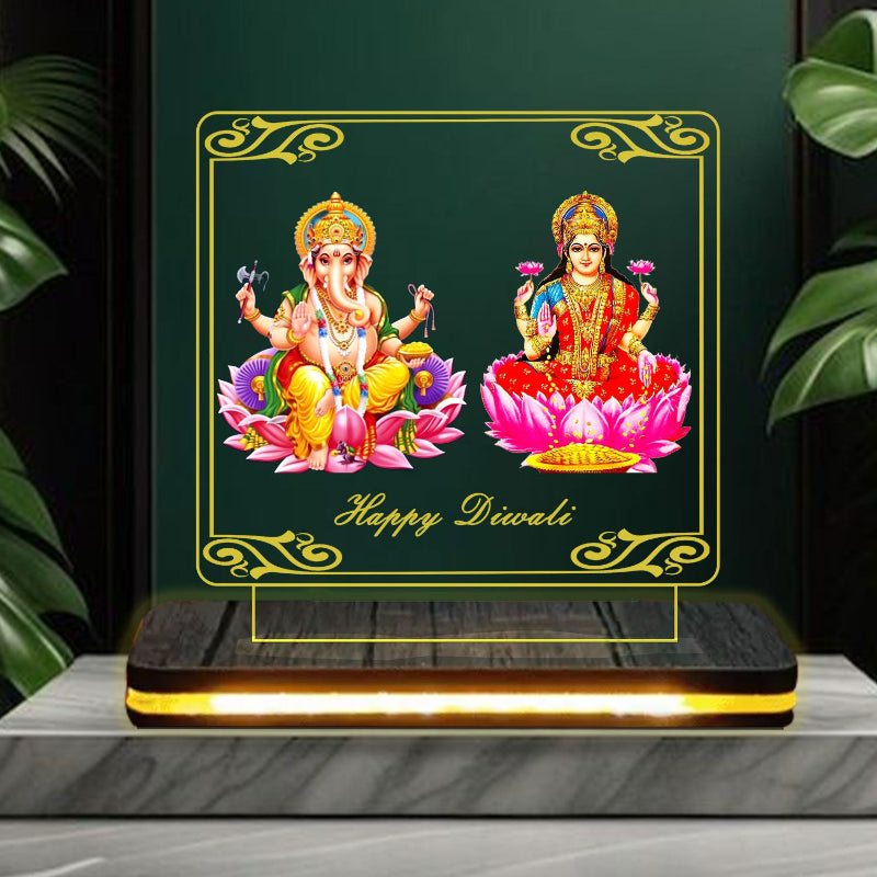 Decorative card with Lord Ganesha and Goddess Lakshmi on lotus flowers with 'Happy Diwali' text, framed by green leaves.