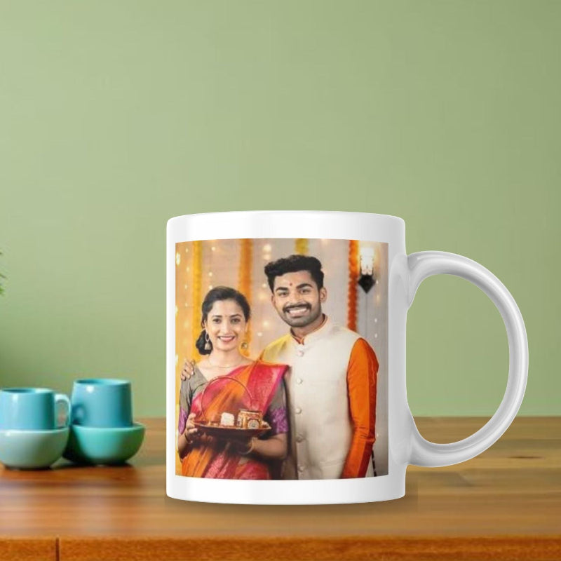 White mug with a printed photo of a couple on a wooden table with a green background
