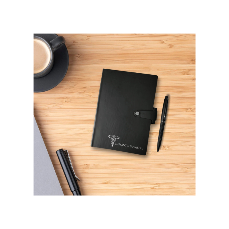 Black notebook with a pen on a wooden surface