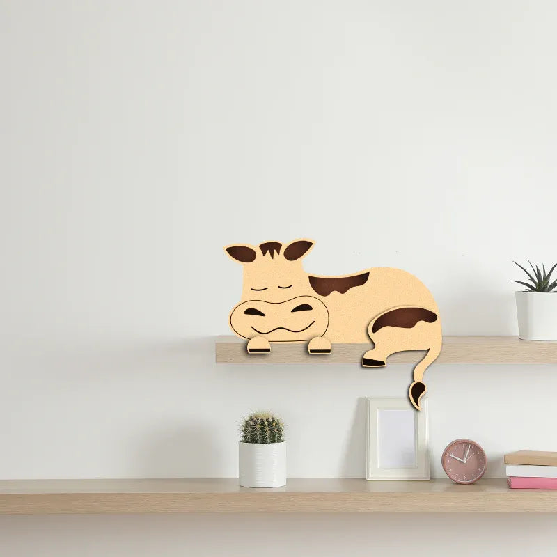 Wooden cow decoration on a shelf with a minimal background