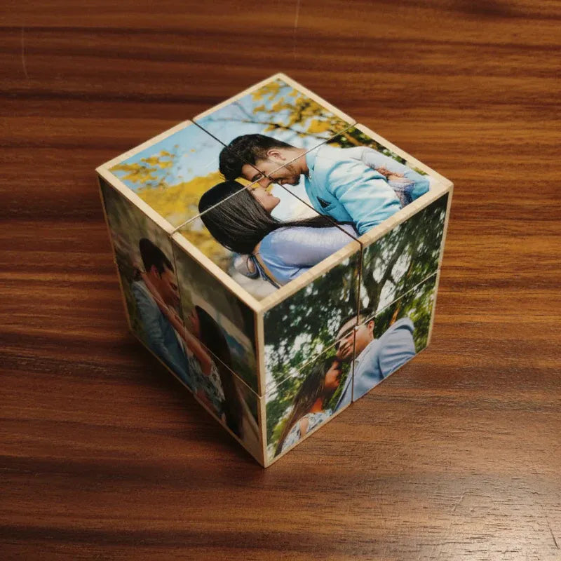 Wooden cube with printed images of a couple on a wooden surface