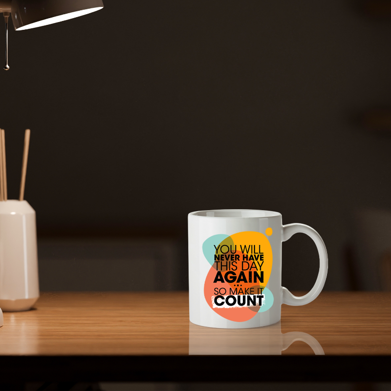 White mug with motivational quote on a wooden surface with a dark background