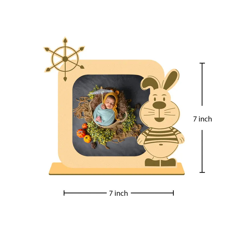 Wooden photo frame with a cartoon rabbit design, containing a baby photo, on a white background.