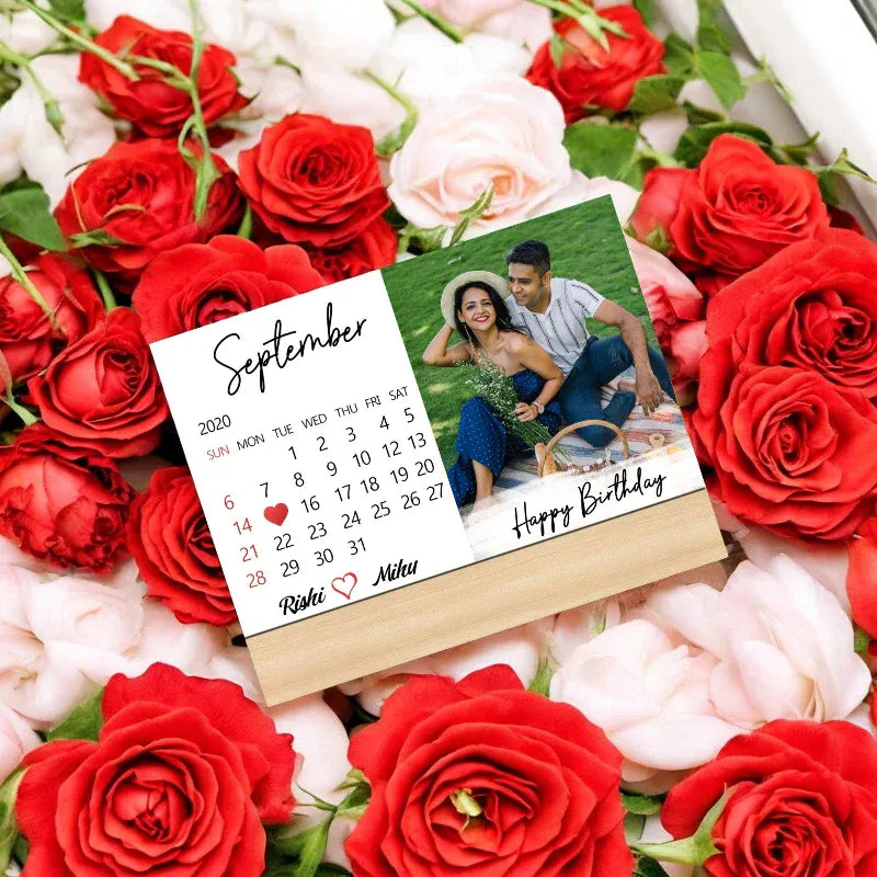 Calendar card with a photo of a couple and 'Happy Birthday' text, surrounded by red and white roses.