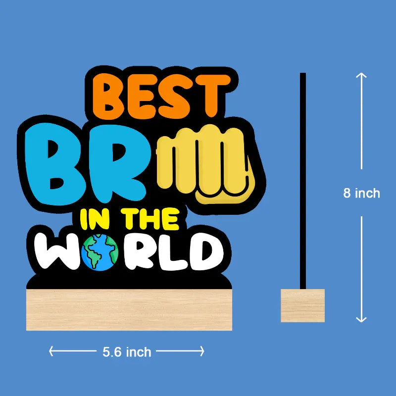 A product dimension diagram on a blue background showing a colorful 'BEST BRICK IN THE WORLD' sign and its stand, with measurements labeled 5.6 inch wide and 8 inch tall.