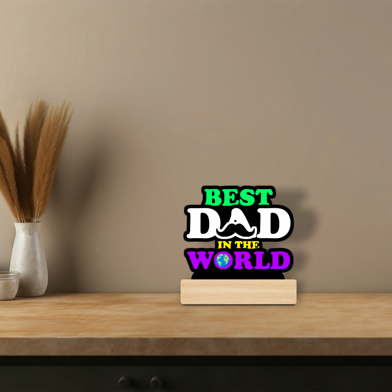 Decorative sign reading 'Best Dad in the World' on a wooden shelf with a neutral background