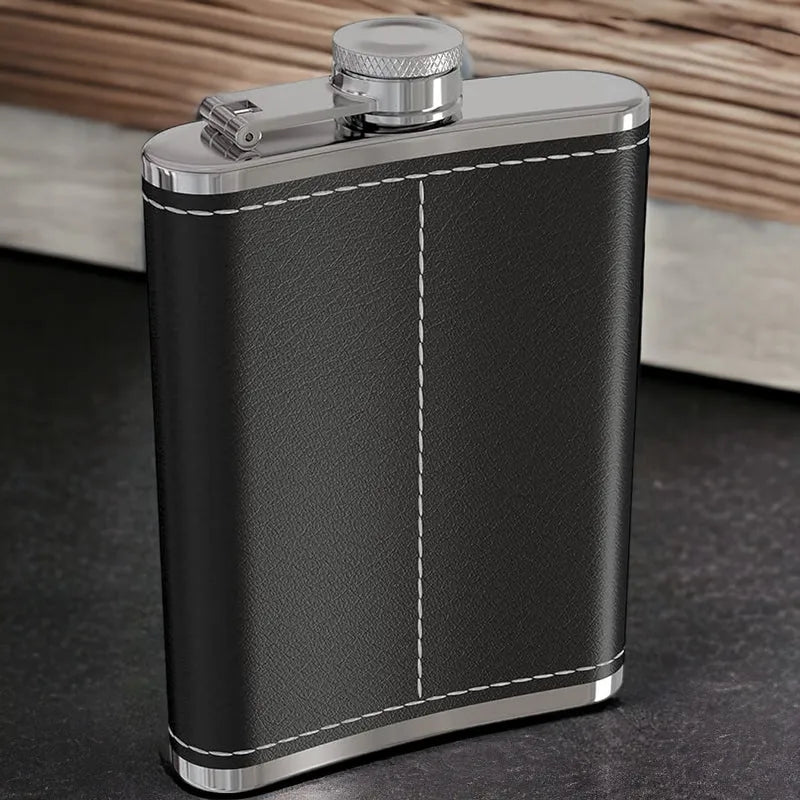 Black leather flask with silver accents on a dark surface