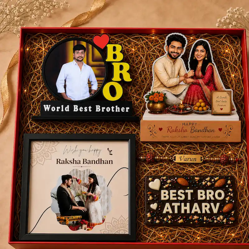 A personalized Raksha Bandhan gift set arranged in a red box with decorative brown paper filler. The set includes a custom photo frame, a custom photo plaque, a chocolate bar, and a Rakhi with 'Bro' and 'Varun' names, all with custom text such as 'World Best Brother' and 'Best Bro Atharv'.