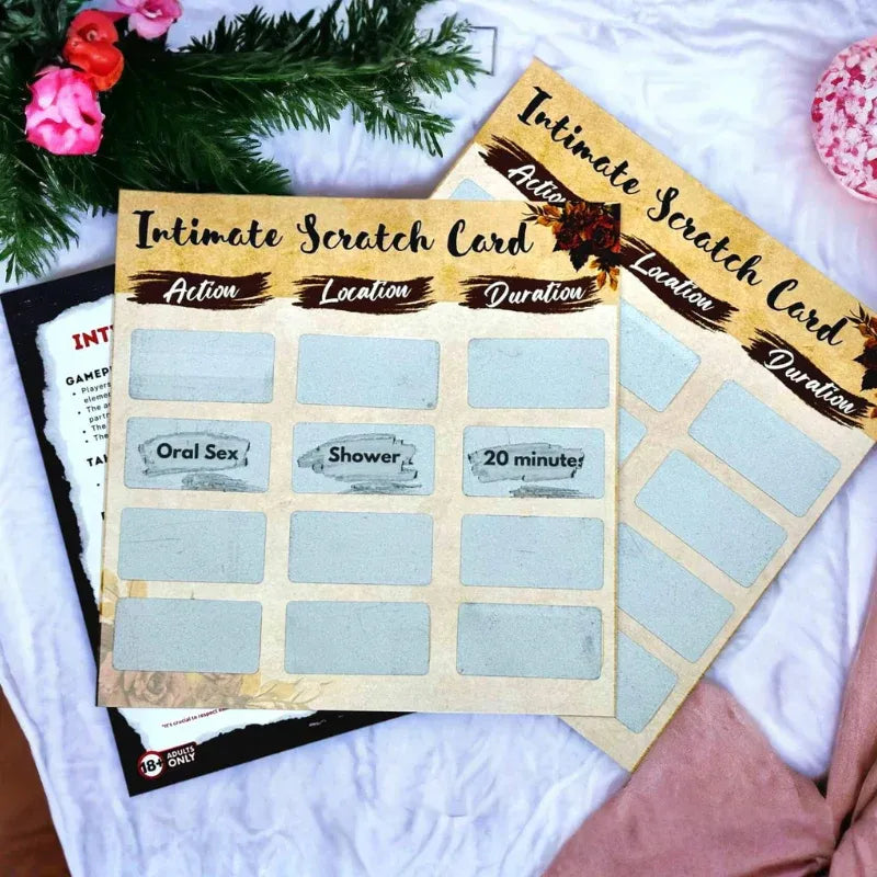 Two 'Intimate Scratch Card' sheets on a white surface with decorative elements.