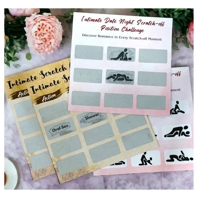 Scratch-off cards with intimate positions on a decorative surface with flowers.