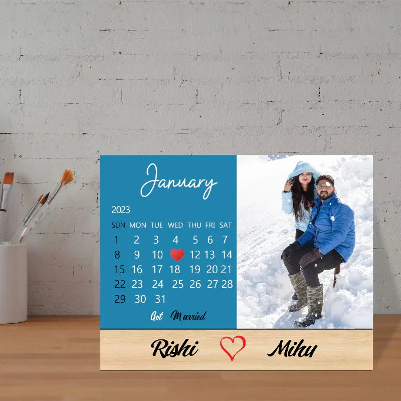Calendar with a custom photo and personalized names on a wooden stand. best 2026 new year gift