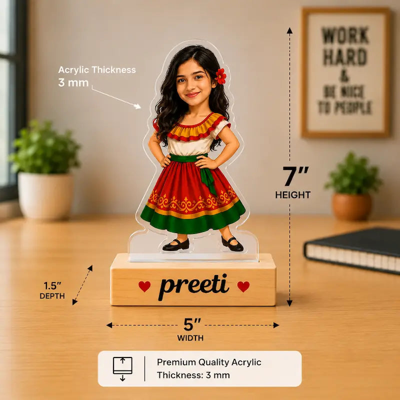 Personalized acrylic standee of a girl with long dark hair wearing a red, green, and white traditional dress, standing on a wooden base printed with the name 'preeti'. The image includes dimension labels showing 7" height, 5" width, and 1.