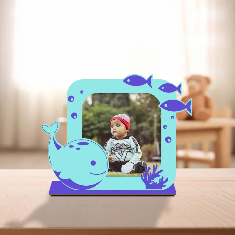 Dolphin baby photo frame — personalised teal acrylic ocean themed frame with smiling dolphin fish and coral design custom baby photo on purple wooden base, unique newborn gift from Zingy Gifts India.