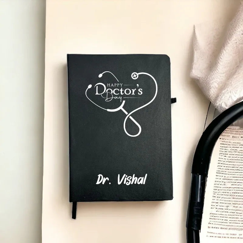 Black notebook with 'Happy Doctor's Day' and a stethoscope design, personalized with 'Dr. Vishal', on a light background.