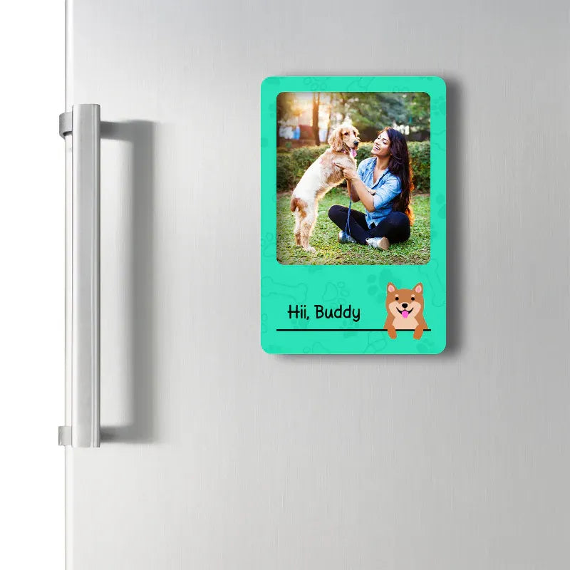 Custom pet fridge magnet with a photo of a woman and dog, text 'Hi, Buddy', and a cartoon dog on a green background.