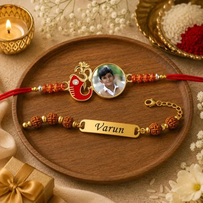 Two personalized Rakhi bracelets displayed on a round wooden tray. One bracelet features a red Om symbol, a circular photo of a young boy, and red beads.