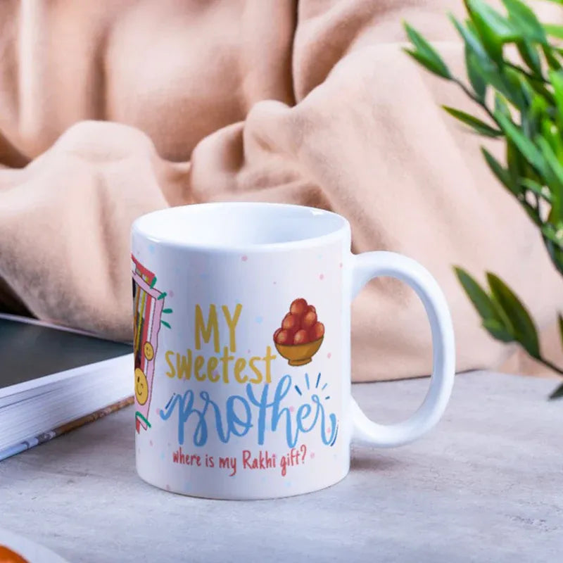 Mug with 'My sweetest brother, where is my Rakhis gift?' text on a table with a blurred background