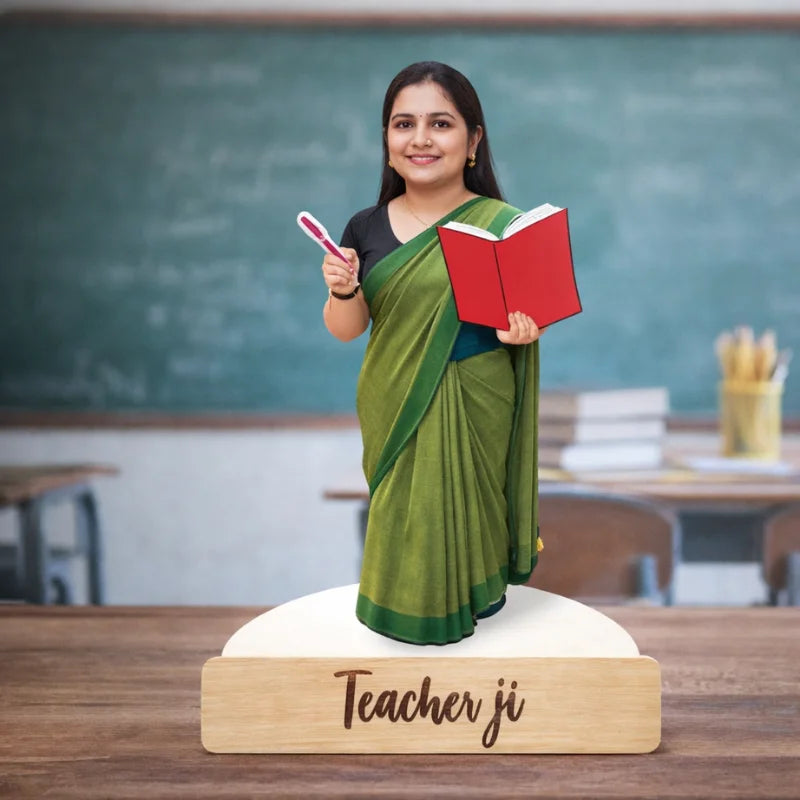 caricature of a teacher holding books in front of a chalkboard, labeled on a wooden base 'Teacher ji'.