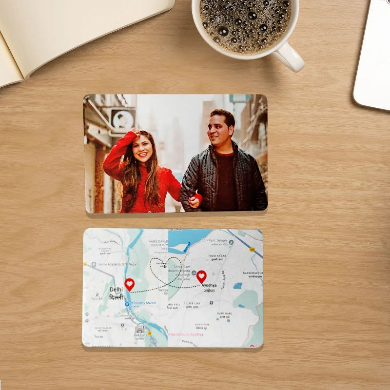Two coasters on a wooden surface with a photo of two people and a map of India.