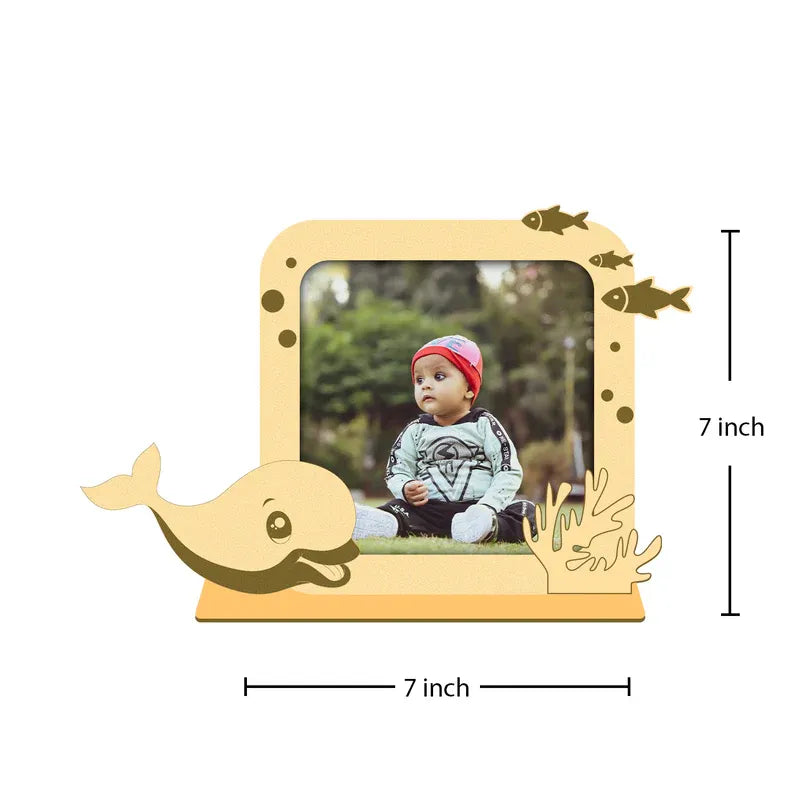 Wooden photo frame shaped like a whale with a child's picture inside, showing dimensions.