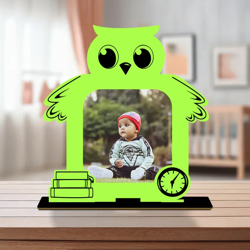 Personalised baby photo frame — bright green owl-shaped acrylic frame with custom baby photo and black wooden base, unique newborn baby gift from Zingy Gifts India.
