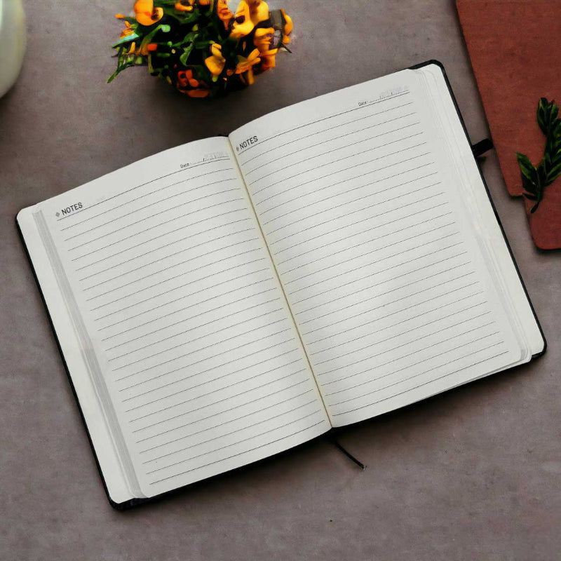 Open notebook with lined pages on a textured surface with decorative elements.