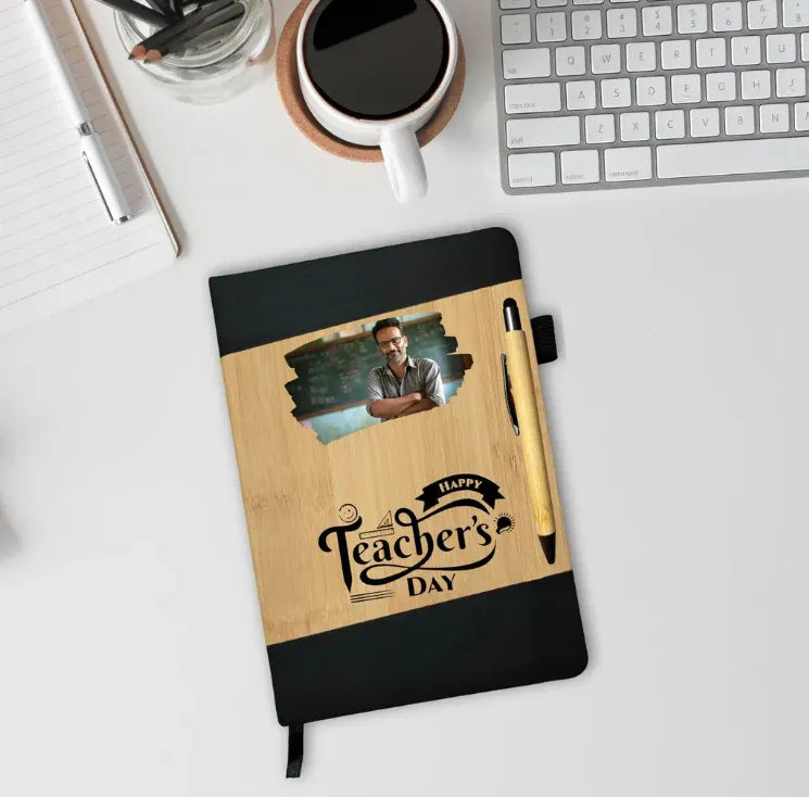 Notebook with 'Happy Teacher's Day' design on a desk with a cup of coffee and keyboard.