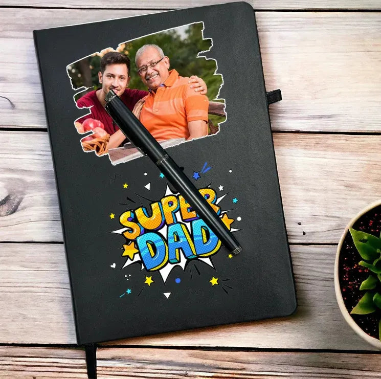 Black notebook with 'Super Dad' design and a photo of a man and an older man on a wooden surface.
