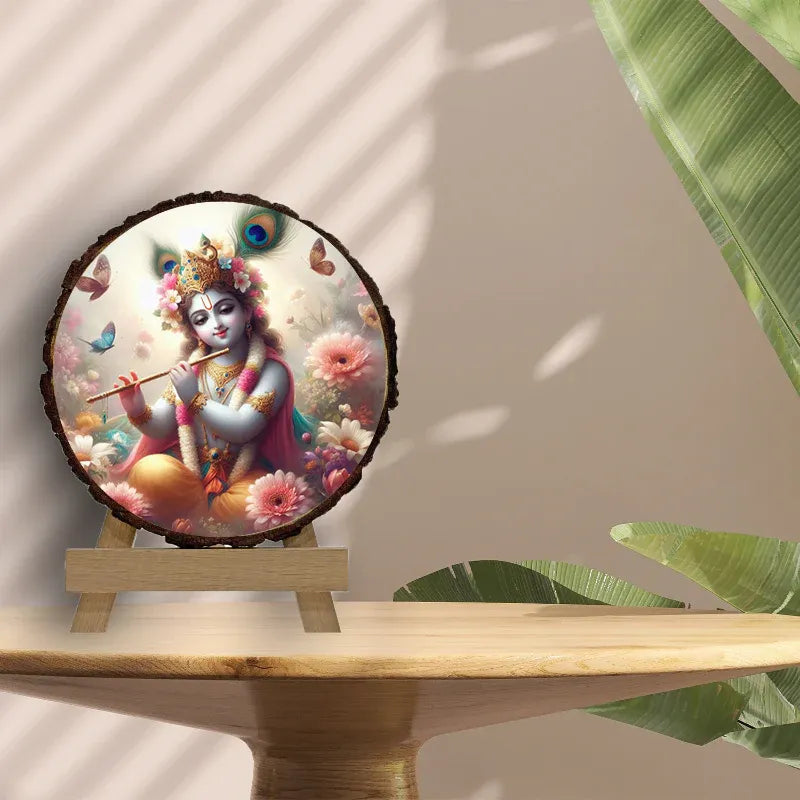 Decorative piece with a colorful depiction of a deity on a wooden stand, surrounded by green leaves.