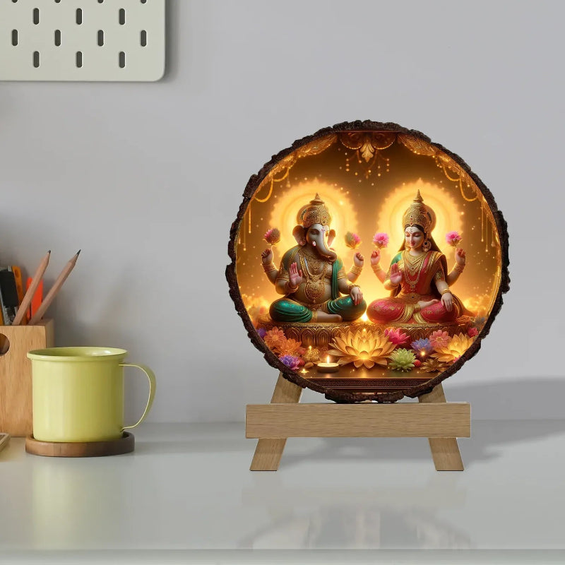 Decorative lamp with two figures on a stand next to a yellow mug.