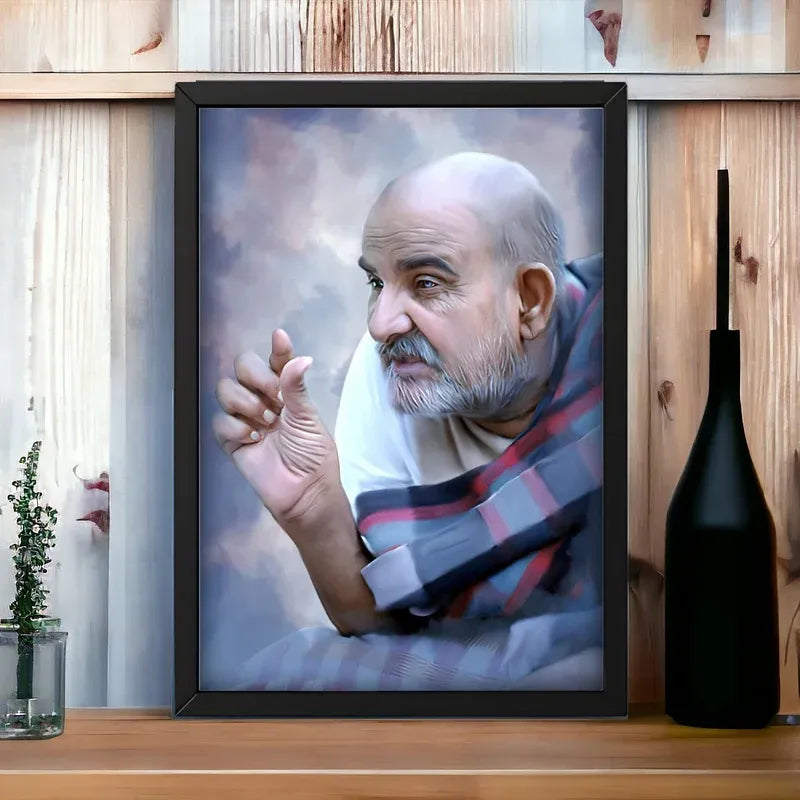 Framed portrait of a man with a beard on a wooden surface with a vase and plant.