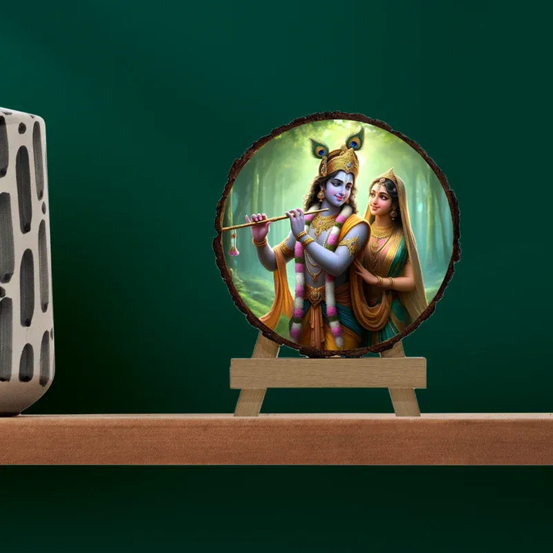 Decorative item with a circular design featuring two figures on a wooden stand against a green background.