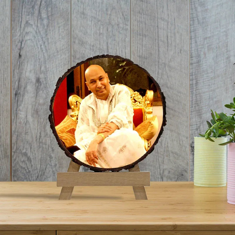 Circular photo frame with a person on a stand against a wooden background
