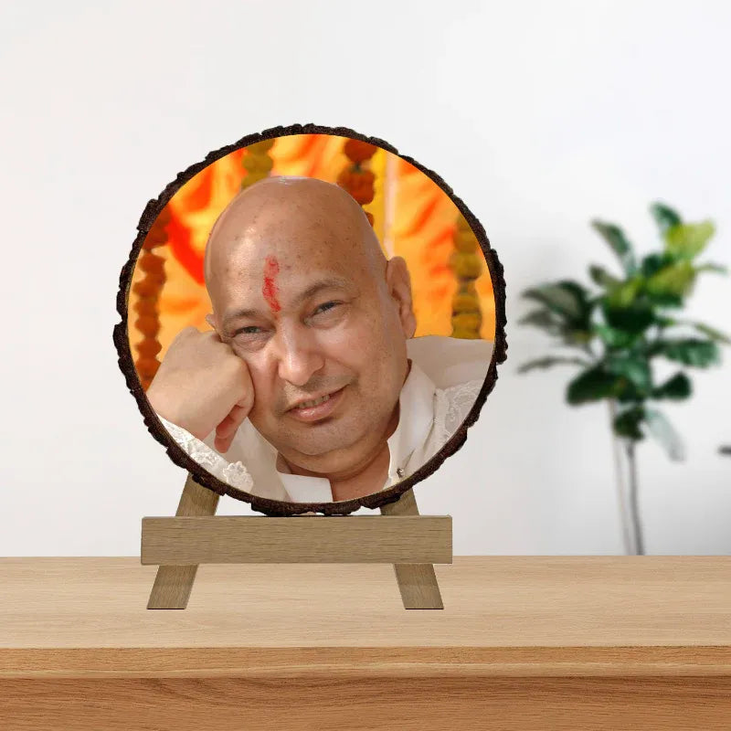 Circular photo frame with a person's face on a wooden stand against a white background