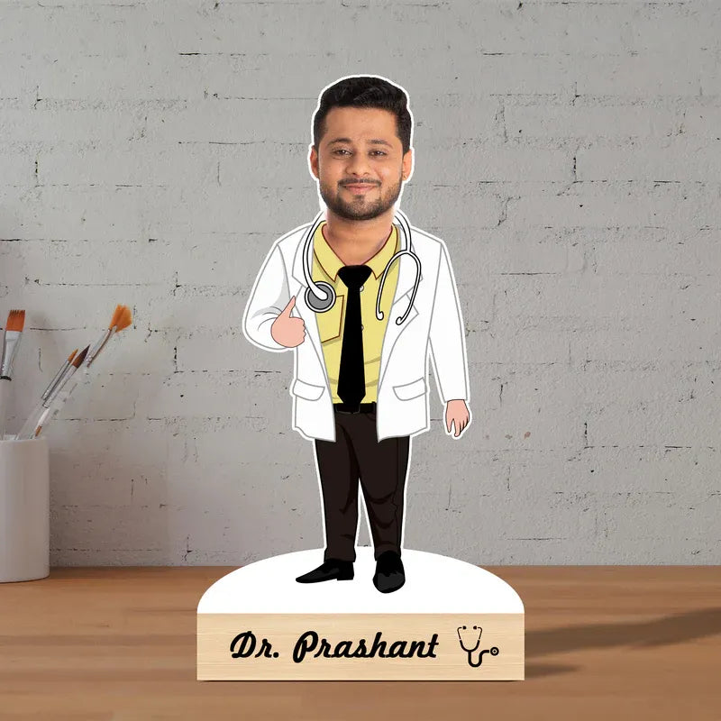 Cardboard cutout of a doctor with a nameplate on a wooden surface and gray brick wall background