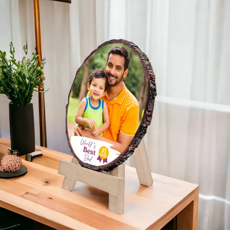 Decorative photo plaque with a father and child photo on a wooden stand.